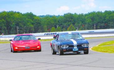 A Corvair and a Corvette head-to-head at the Pocono Raceway.
