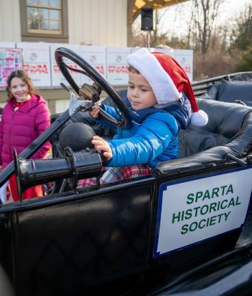 Sean Quinn of Byram sits in the Sparta Historical Society’s Ford Model T, which was part of the Touch-a-Truck display at the Sparta Train Station on Dec. 9. (Photo by Nancy Madacsi)
