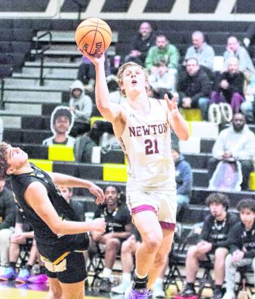 Newton's Nick Kurilko jumps during a shot in the first half. Kurilko scored 17 points.