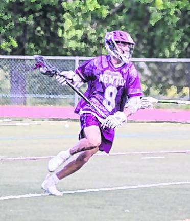 Newton's Matt Ellsworth carries the ball with his crosse. Ellsworth scored 1 goal.