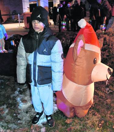 Noa Boyer of Newton stands by a dog inflatable.