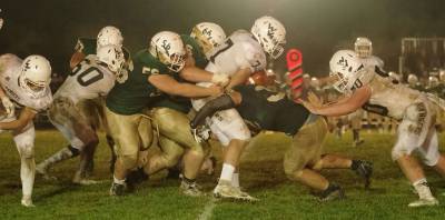 Wallkill Valley quarterback Alex Mastroianni holds onto the ball as Sussex Tech defenders grab him in the second half.