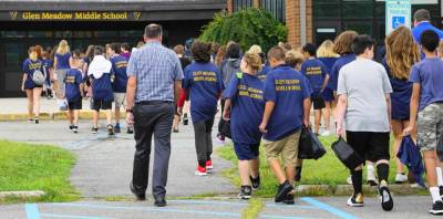 Seventh-graders enter Glen Meadow Middle School on the first day of school.