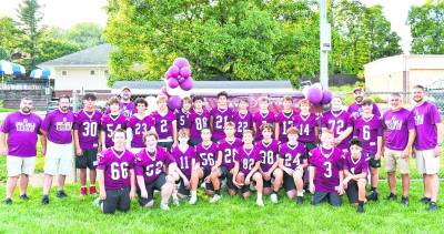 The eighth-grade football team poses for a photo.