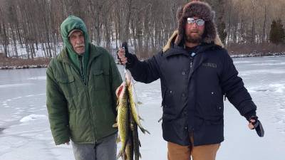 Tadeusz Koscien fishing with his godfather. He enjoys the bonding time out on the ice