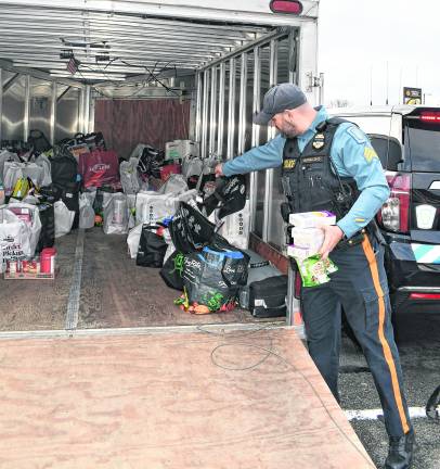 Sgt. Chris Spaldo shows the donated items on the truck.