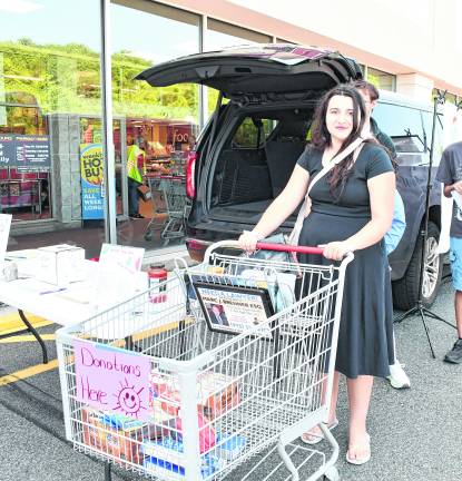 <b>Reagan Morrison of the High Point School Work based learning program is shown with a shopping cart.</b>