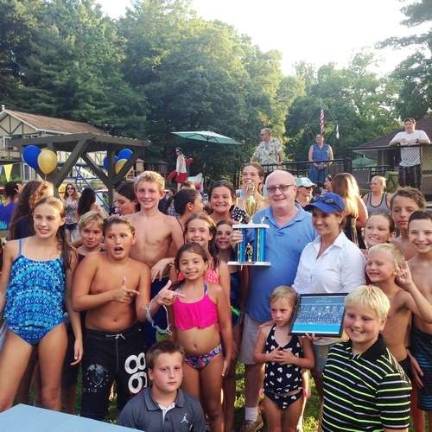 Lake Mohawk Pool owner Greg Leo surrounded by swim team members after a tournament win in 2016 Photos by Rose Sgarlato