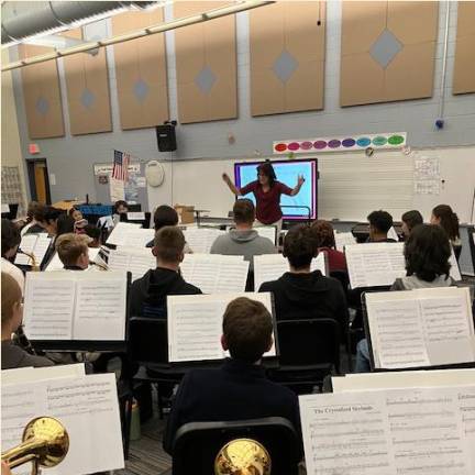 <b>Lucille Kincaid leads the 89-member All-Sussex County Chorus at Sparta High School.</b>