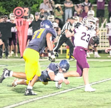 Newton running back Reid Corino carries the ball.