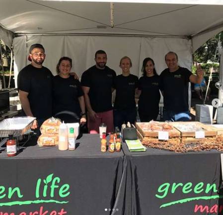 Ramez and Alaa Yassin (center) spend a lot of time at the Andover store. They are pictured here with the Andover Green Life staff.