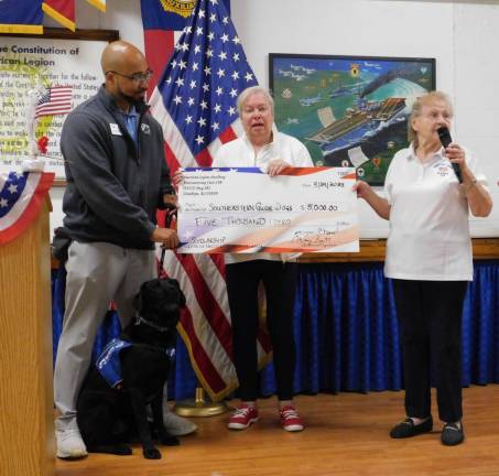 Members of Auxiliary Unit 278 of the Musconetcong American Legion Post 278 in Stanhope present U.S. Army Sgt. (Ret.) Sean Brown and his service dog, Nick, with a check for $5,000 to support the nonprofit Southeastern Guide Dogs.
