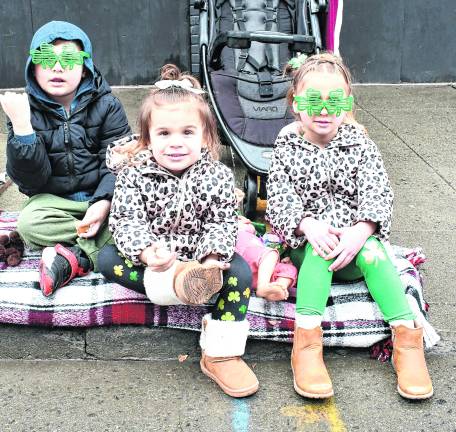 Layton, Delaney and Dakota Tashijan, all of Newton, wait for the parade.
