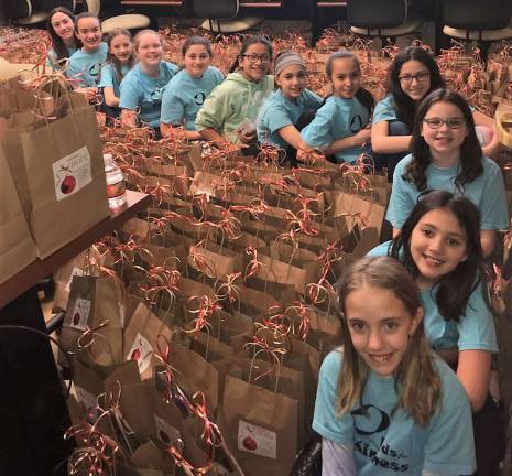 Sorting 4,000 cookies into goody bags sounds like a job for Cookie Monster, or kind-hearted child elves. The later volunteered to help Project-Self-Suffiency stuff goody bags that will be given to families who needed a helping hand this holiday. The parents will be given a bag when entering the "Toy Shop" this weekend to pick up toys to brighten their children's holiday.