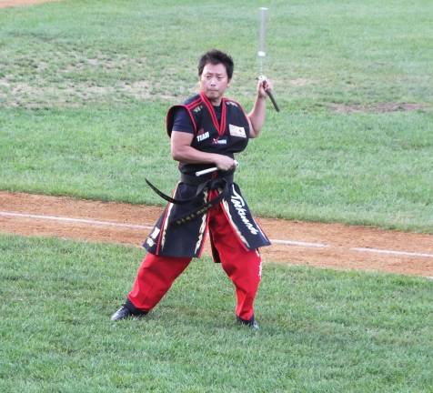 Master Ken Lee demonstrates nunchaks skills before the start of the baseball game. Master Ken is the founder and an instructor at Master Ken's Xtreme Martial Arts Center in Hamburg.
