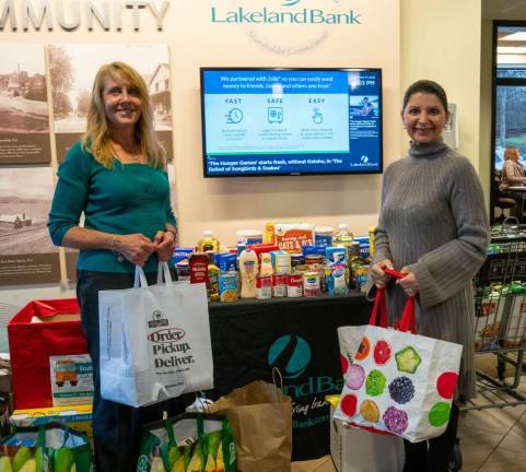 Susan Wilke and Mira Cocozziello drop off donations at Lakeland Bank in Sparta.
