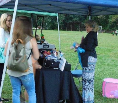 Janice Harrison of Pixie Painters creates balloon art at the Andover Regional PTA Ice Cream Social