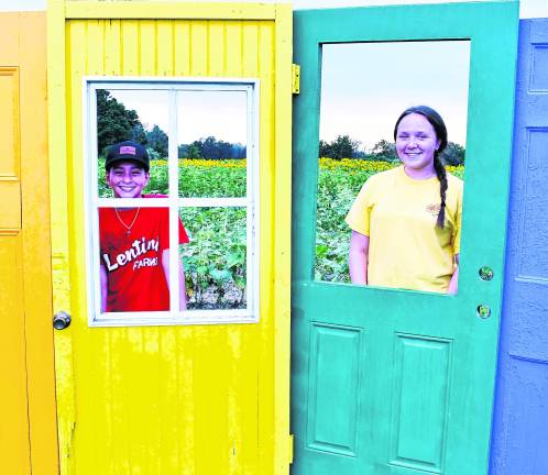 Joie and Audrinia Trogani of Hampton pose for a photo behind doors.