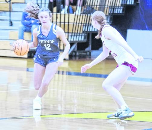 Vernon's Monica Curry dribbles the ball while covered by Newton's Avery Eigner. Curry scored 23 points.