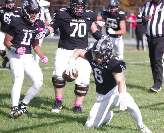 After he successfully rushed into the end zone for a touchdown Wallkill Valley running back Travis Barlow (6) and his teammates celebrate in the first half.