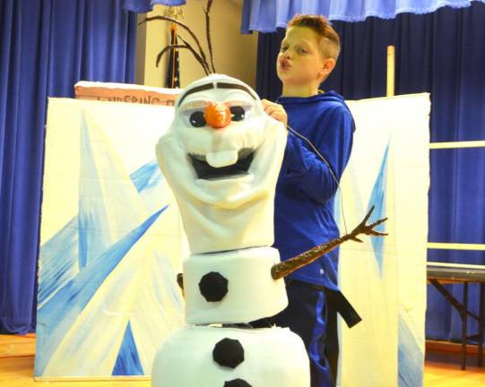 Tate Elvin, plays the role of Olaf, sings a song during rehearsal of Pope John XXIII Middle school’s presentation of Disney’s “Frozen JR.” on Monday at Reverend George A. Brown’s McKenna Hall.