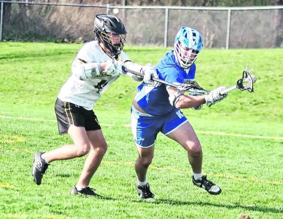 West Milford's Dean Lombardo reaches in with his crosse to try to dislodge the ball from Kittatinny's Jack Brex.