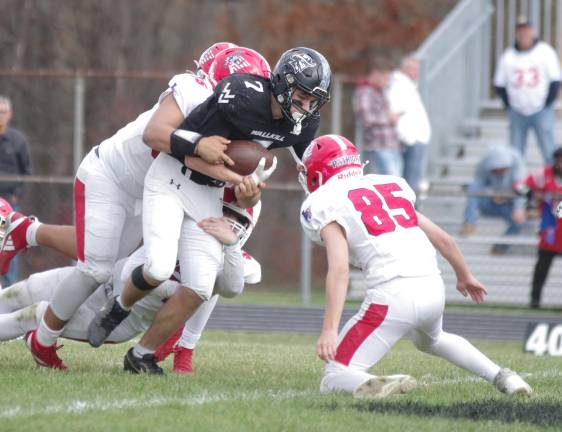 Lenape Valley defenders pounce on Wallkill Valley ball carrier Scottie Weiss. Weiss rushed for 78 yards and scored 1 touchdown.