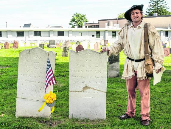 <b>Matt Kuever poses by a gravestone.</b>
