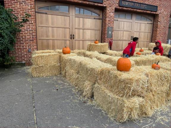 Xavier Jenkins, 10, left, and Jace Fountain, 3, play in a maze made of hay bales.