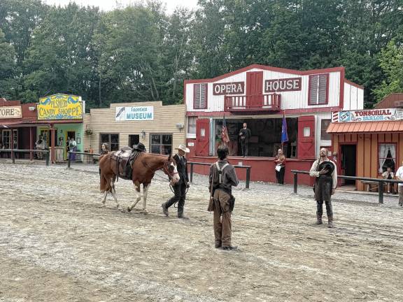 Cowboy Gabe Wellington walks Ranger into town during an empty saddle ceremony honoring the late Robert ‘Pony Bob’ Erven on Saturday, July 26 at Wild West City in Byram. (Photo by Aidan Mastandrea)