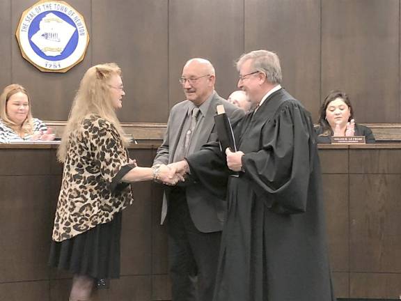 Municipal Court Judge James Sloan congratulates Councilwoman Sandra Lee Diglio after she is sworn in.