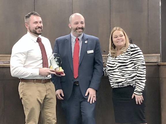 Former Newton Mayor Jason Schlaffer, left, holds an award presented to him by Councilman Matthew Dickson and new Mayor Michelle Teets at the reorganization meeting Jan. 5.