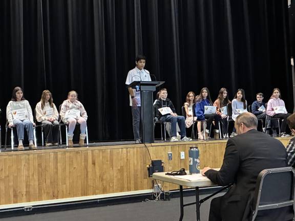 Seventh grader Eddie Arias, at podium, won the Delaware Valley Middle School spelling bee on Monday, Jan. 12 with the word “tournament.”