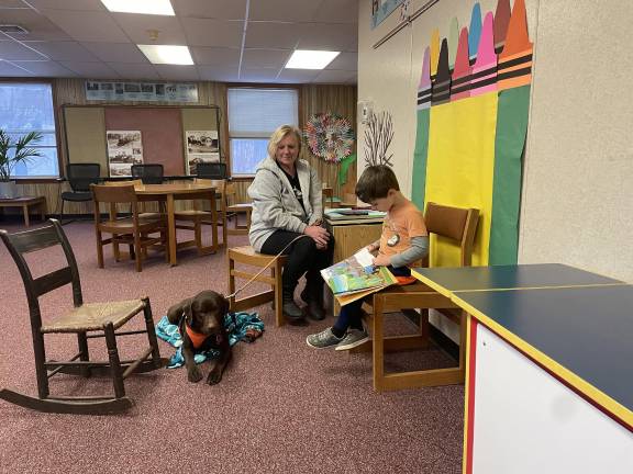 <b>Reading to a therapy dog at the Franklin Branch. Photo provided.</b>