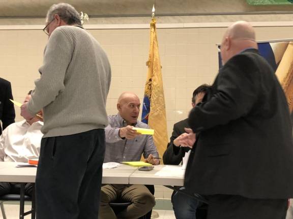 Eugene Wronko, secretary of the Sussex County Republican Committee, hands out ballots.