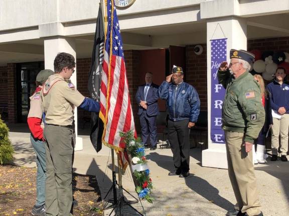 Members of the American Legion Post 86 Honor Guard salute after presenting wreaths.
