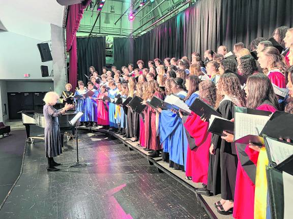 <b>Lucille Kincaid conducts the High School Chorus.</b>