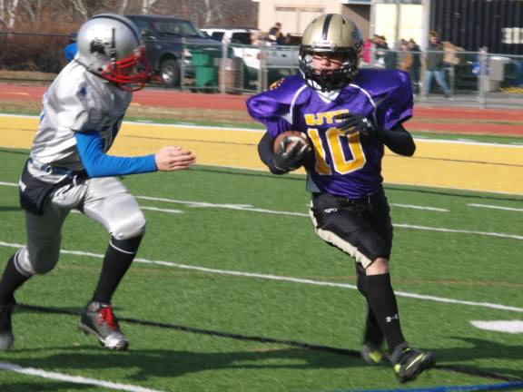 Purple pee wee team running back Ray Gorny is on the move. Gorny plays for the West Milford Highlanders.