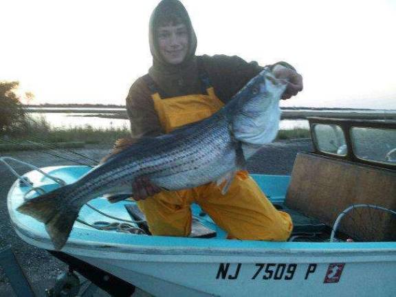 Kazar with a sizable striped bass.