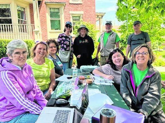 <b>Volunteers maintain the community gardens at Project Self-Sufficiency.</b>