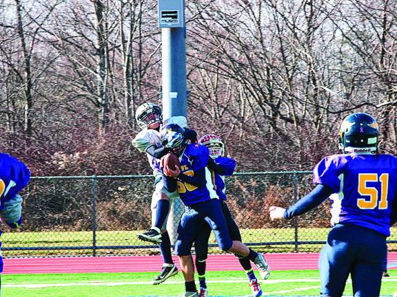 Purple cornerback Zack Biango (68) intercepts the ball in the pee wee game.
