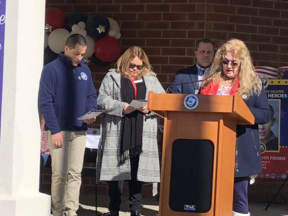 Newton Councilwoman Sandra Lee Diglio reads names of the honorees during the ceremony. At left are Deputy Mayor John-Paul Couce and Mayor Michelle Teets.
