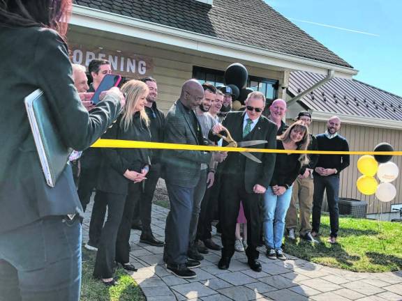 Brian Dowling cuts the ribbon at the grand opening of Sussex Cultivation.