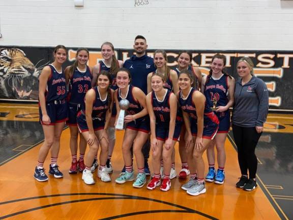 The Lenape Valley girls basketball team poses with a trophy after the Hackettstown Holiday Tournament championship game, which it won in overtime. (Photo by Claire Callaghan)