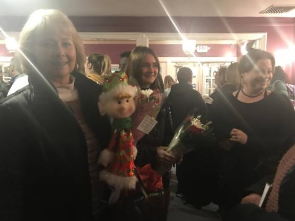 In the lobby of The Newton Theatre, Nancy Davidson holds an elf doll and flowers to later present to her 8-year-old granddaughter Maddy who played the part of Elf Number Two in the performance of Elf Jr last weekend.