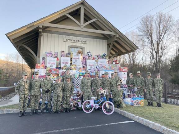 Members of the Travis Manion Battalion U.S. Naval Sea Cadet Corps pose with donated toys at Sparta Station. The group, based at Picatinny Arsenal, helped load the toys onto Operation Toy Train.