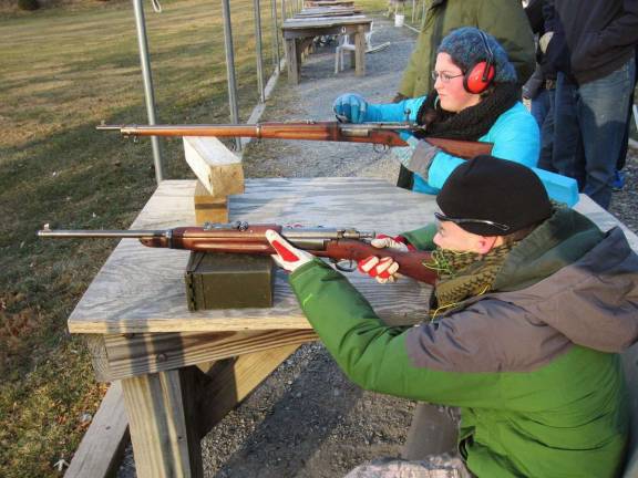Stephen Rozek (Crew Secretary) and Grace Seltzer (Crew Treasurer) fire two of the rifles they learned about.