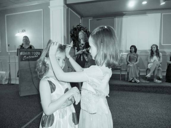 Photos By Amy Stewart Paige McVeigh lets her friend, Cameron Ecke, try on her tiara.