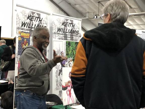 Comic book artist Keith Williams talks to a visitor at Winter Fest ’24. (Photo by Kathy Shwiff)