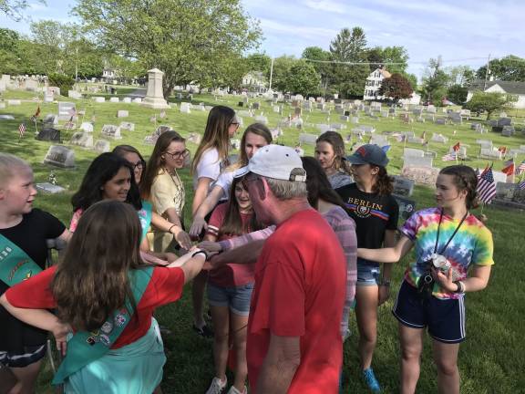 Troops 770 and 96136, along with U.S. Marines Jim Brady and Clint Roy, placed flags on graves of deceased, local U.S. Marines to commemorate Memorial Day. (Photos provided)